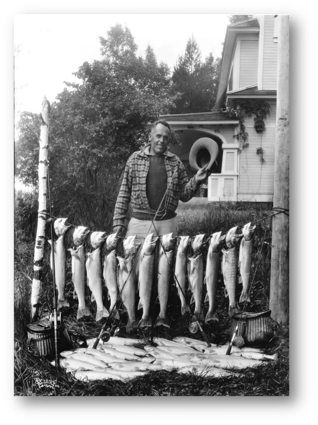 Jack Lloyd displays the fish he and two friends caught on Kootenay Lake in 1929. In the background is the Balfour Beach Inn. Photograph courtesy of the Northwest Museum Arts & Culture. Photographer Charles Libby, Spokane.